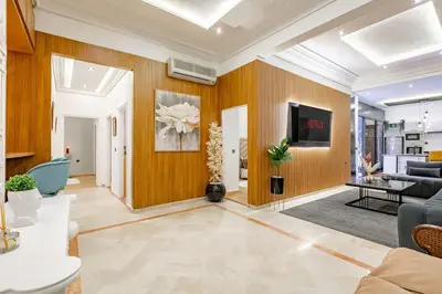 a living room with a couch and a tv at Villa YOGA Guéliz Centre-Ville in Marrakech