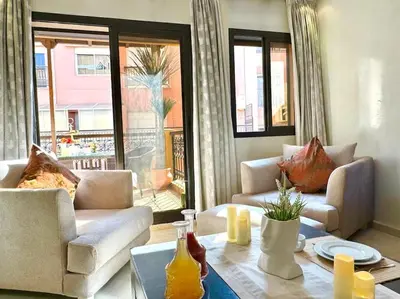 a living room with two couches and a table at Piscine Guéliz Center Yoga in Marrakech