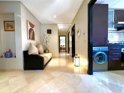 a living room with a couch and a washing machine at Piscine Guéliz Center Yoga in Marrakech