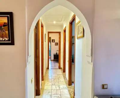 a hallway with an archway in a house at Paradis à marrakech Grande Piscine in Marrakech