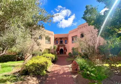 a large house with a brick driveway at Paradis à marrakech Grande Piscine in Marrakech