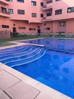 a large swimming pool in front of a building at Tulipe Family House-Pool and Parking in Marrakech