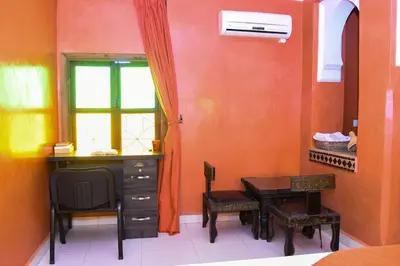 a room with a desk and a table and a window at Appartement Riad élégant chic au cœur de Guéliz in Marrakech