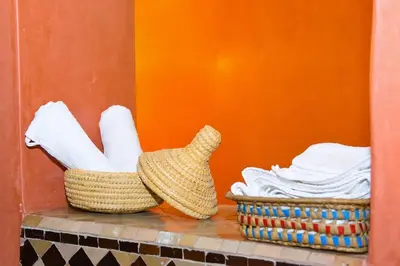 a basket of towels and a basket of towels at Appartement Riad élégant chic au cœur de Guéliz in Marrakech