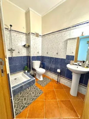 a bathroom with a toilet and a sink and a tub at Gueliz Marrakech in Marrakech