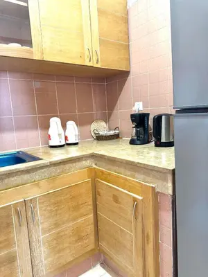 a kitchen with wooden cabinets and a counter top at Gueliz Marrakech in Marrakech