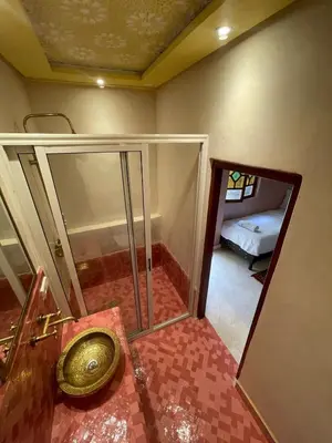 a bathroom with a sink and a mirror at Riad Naffar in Marrakech