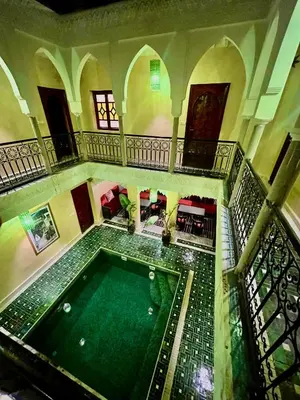 an overhead view of a swimming pool in a building at Riad Naffar in Marrakech