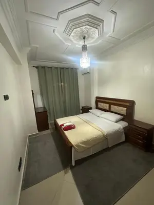 a bedroom with a bed and a chandelier at Appartement Lana Guéliz Marrakech in Marrakech