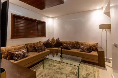 a living room with a couch and a glass table at Duplex with private pool in Marrakech