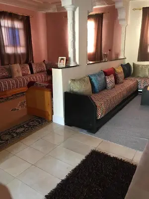 a living room with a couch with pillows on it at Dari in Marrakech
