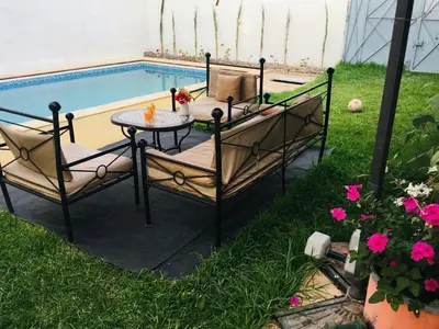 a patio with a table and chairs next to a pool at Dari in Marrakech