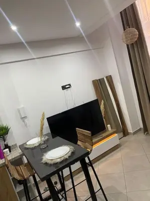 a dining room with a black table and chairs at La Bohéme - Duplex Neuf - Modern & Chic - Proche Gare - Confort - CLIM Parking et WIFI Gratuit ! GUELIZ in Marrakech