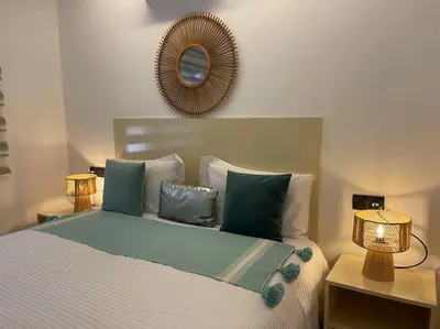 a bedroom with a bed with two lamps and a mirror at La Bohéme - Duplex Neuf - Modern & Chic - Proche Gare - Confort - CLIM Parking et WIFI Gratuit ! GUELIZ in Marrakech