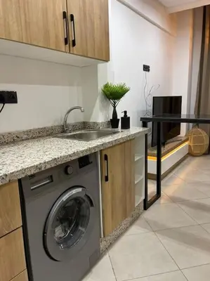 a kitchen with a washing machine and a sink at La Bohéme - Duplex Neuf - Modern & Chic - Proche Gare - Confort - CLIM Parking et WIFI Gratuit ! GUELIZ in Marrakech
