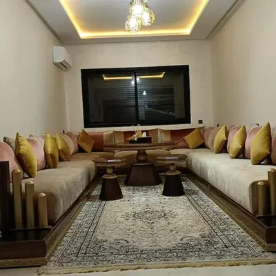 a living room with two couches and a flat screen tv at superbe appartement à côté de la gare à Gueliz Marrakech in Marrakech