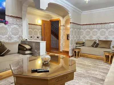 a living room with a couch and a table at Cozy Apartment near airport in Marrakech