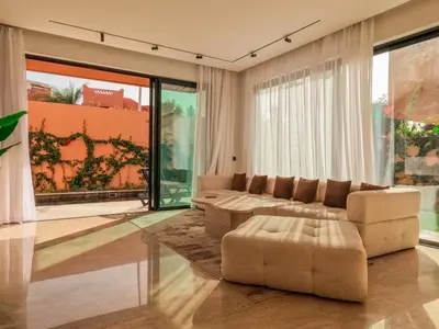 a living room with a couch and a table at Villa iris in Marrakech