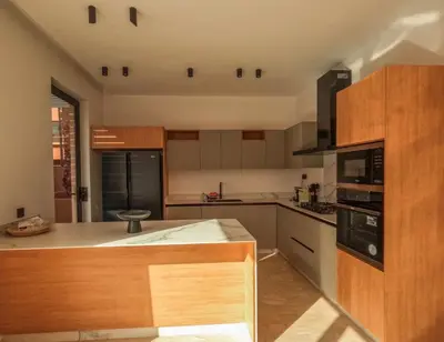 a kitchen with wooden cabinets and a counter top at Villa iris in Marrakech