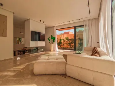a living room with a couch and a large window at Villa iris in Marrakech