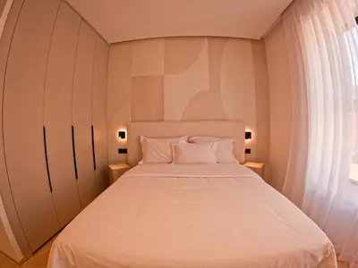 a bedroom with a large white bed with a window at Villa iris in Marrakech