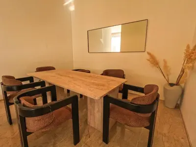 a dining room with a wooden table and chairs at Villa iris in Marrakech