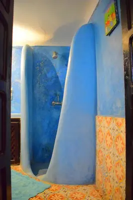 a blue bath tub in a room at Riad les ANGES DU DESERT in Marrakech