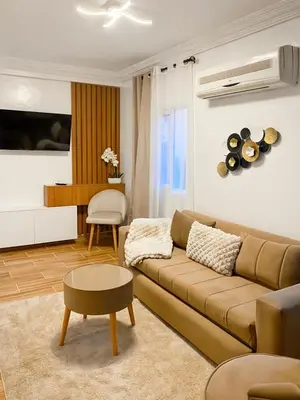 a living room with a couch and a table at Appart Cosy in Marrakech