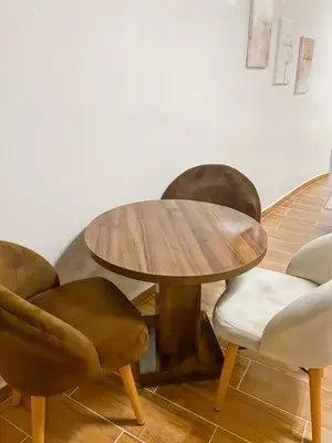 a wooden table and chairs in a room at Appart Cosy in Marrakech