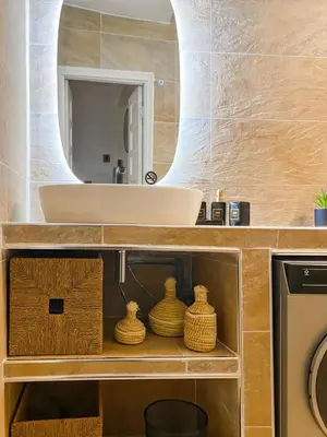 a bathroom with a sink and a mirror at Appart Cosy in Marrakech