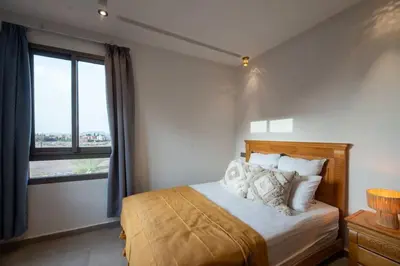 a bedroom with a bed and a large window at Villa Targa in Marrakech