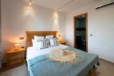 a bedroom with a large bed with white pillows at Villa Targa in Marrakech
