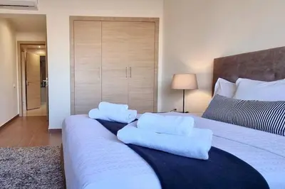a bedroom with a bed with white pillows on it at Charming apartment in Agdal in Marrakech
