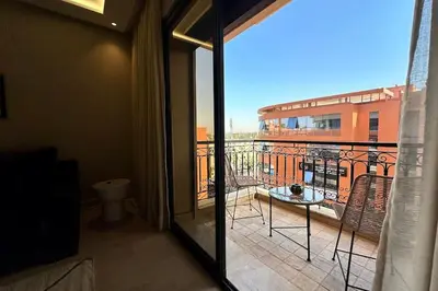 a room with a balcony with a view of a building at Apartment in the heart of Marrakech in Marrakech