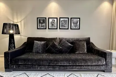 a couch in a living room with pictures on the wall at Apartment in the heart of Marrakech in Marrakech