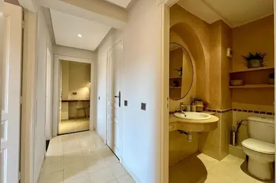 a bathroom with a toilet and a sink and a mirror at Central Gueliz with Pool and Terrace in Marrakech
