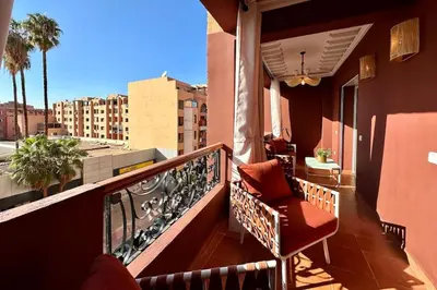 a balcony with a chair and a view of a city at Central Gueliz with Pool and Terrace in Marrakech