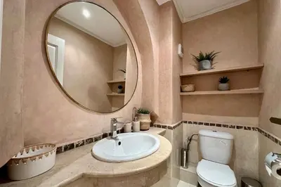 a bathroom with a sink and a mirror at Central Gueliz with Pool and Terrace in Marrakech