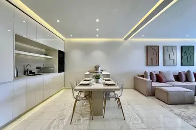 a kitchen and living room with a table and a couch at Central Gueliz with Pool and Terrace in Marrakech