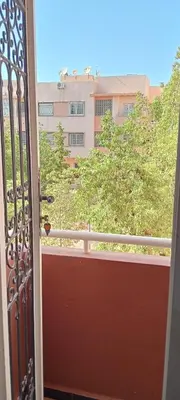 an open door to a balcony with a building at Jnan chrifiya in Marrakech