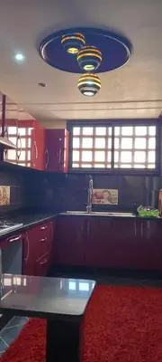 a kitchen with a sink and a red rug at Jnan chrifiya in Marrakech