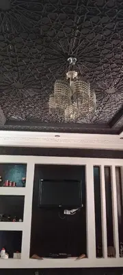 a ceiling with a chandelier and a tv at Jnan chrifiya in Marrakech