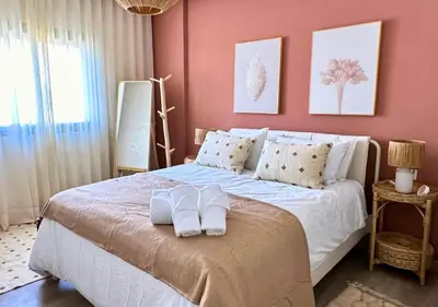 a bedroom with a bed with two towels on it at Reflet du Désert Appartement bohème à Marrakech in Marrakech