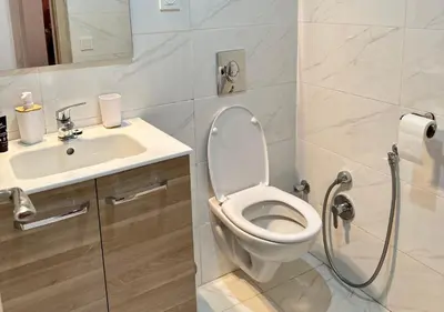 a bathroom with a toilet and a sink at Reflet du Désert Appartement bohème à Marrakech in Marrakech