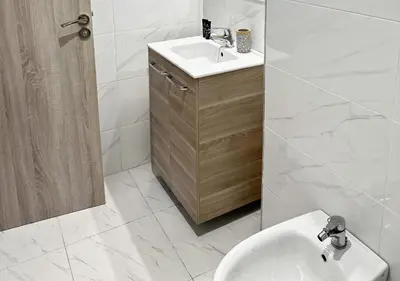 a white bathroom with a sink and a toilet at Sérénité au coeur de Marrakech in Marrakech