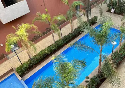 an overhead view of a swimming pool with palm trees at Sérénité au coeur de Marrakech in Marrakech