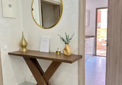 a table with a mirror and two vases on it at Trésor andalous in Marrakech