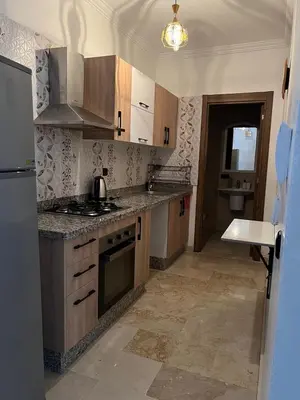 a kitchen with a sink and a stove top oven at Cozy Nour in Marrakech