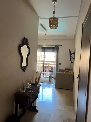 a living room with a table and a couch at Cozy Nour in Marrakech