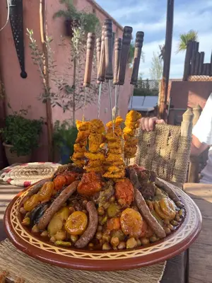 a plate of food with sausage and other foods on a table at Riad Dutilleul in Marrakech